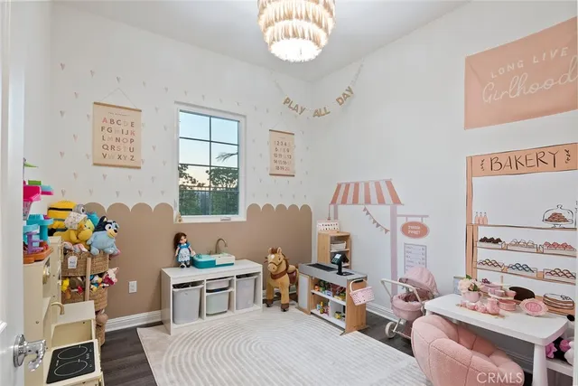 a view of a backyard with couches potted plants and wooden fence