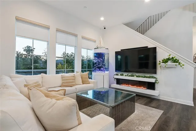 a living room with kitchen island furniture and a wooden floor
