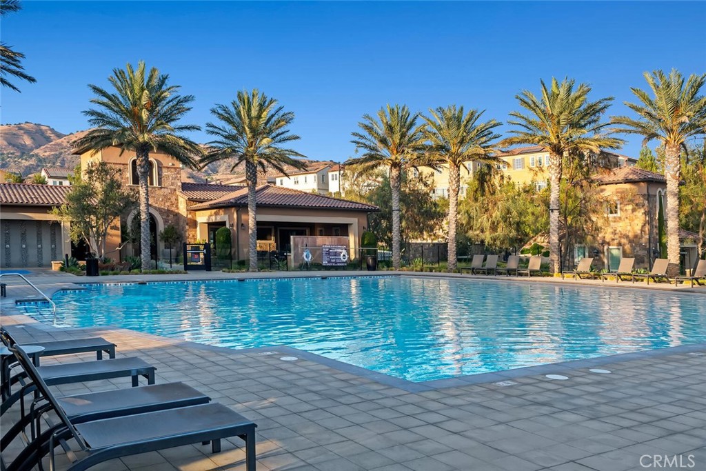 20732 Beech Circle Porter Ranch, CA 91326 - Photo 63 of 72 a view of a swimming pool with a table and chairs