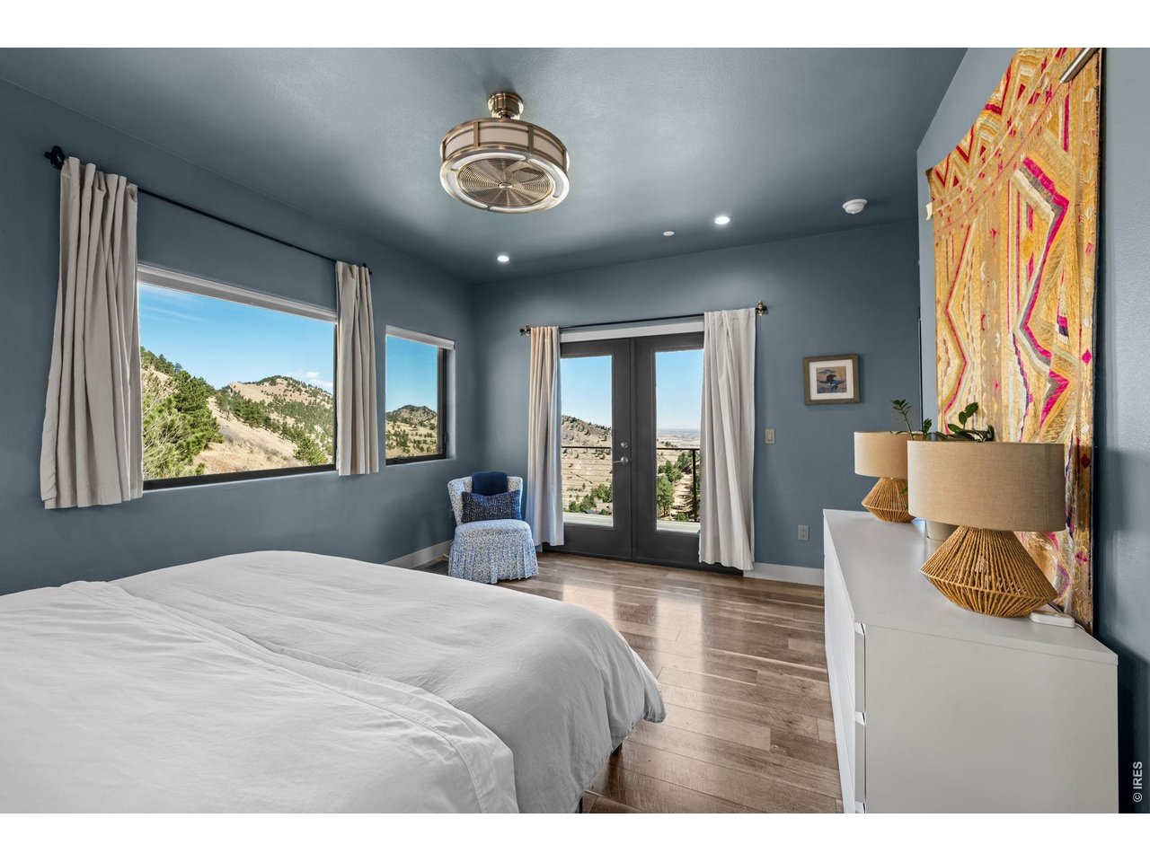 865 North Cedar Brook Road Boulder, CO 80304 - Photo 21 of 49 a bedroom with a large bed and a painting on the wall