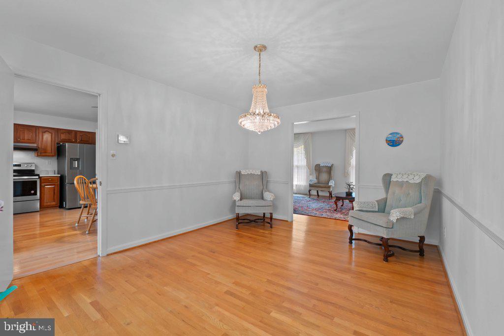 9704 Hall Road Potomac, MD 20854 - Photo 11 of 41 a living room with furniture and a chandelier