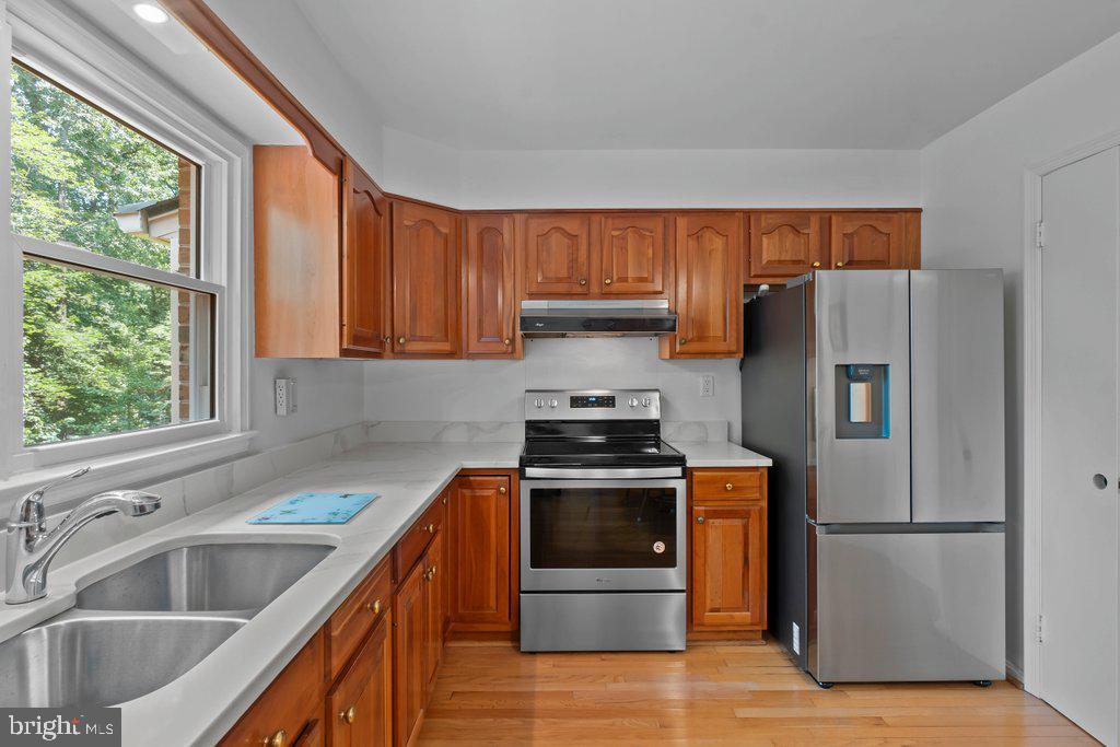 9704 Hall Road Potomac, MD 20854 - Photo 14 of 41 a kitchen with a stove a refrigerator and a sink