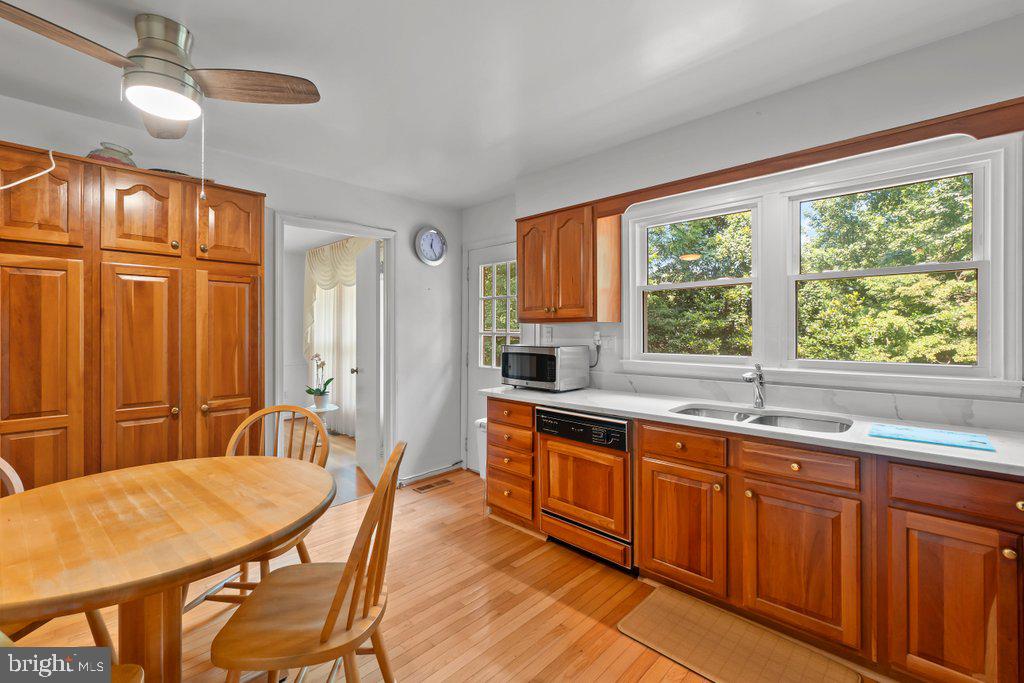 9704 Hall Road Potomac, MD 20854 - Photo 18 of 41 a large kitchen with cabinets table and chairs