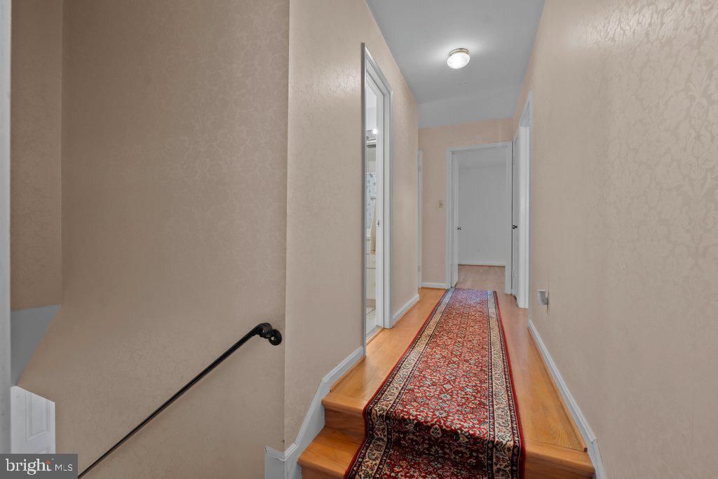 9704 Hall Road Potomac, MD 20854 - Photo 23 of 41 a view of hallway with wooden floor