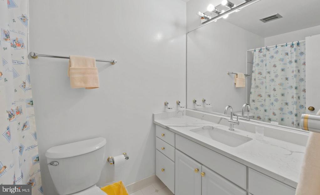 9704 Hall Road Potomac, MD 20854 - Photo 28 of 41 a bathroom with a sink toilet vanity and shower