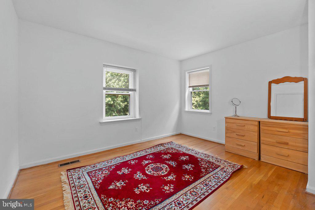 9704 Hall Road Potomac, MD 20854 - Photo 29 of 41 a bedroom with a bed and a dresser in it