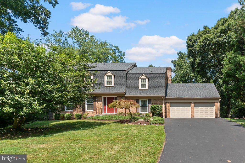 9704 Hall Road Potomac, MD 20854 - Photo 3 of 41 a front view of a house with a garden and plants