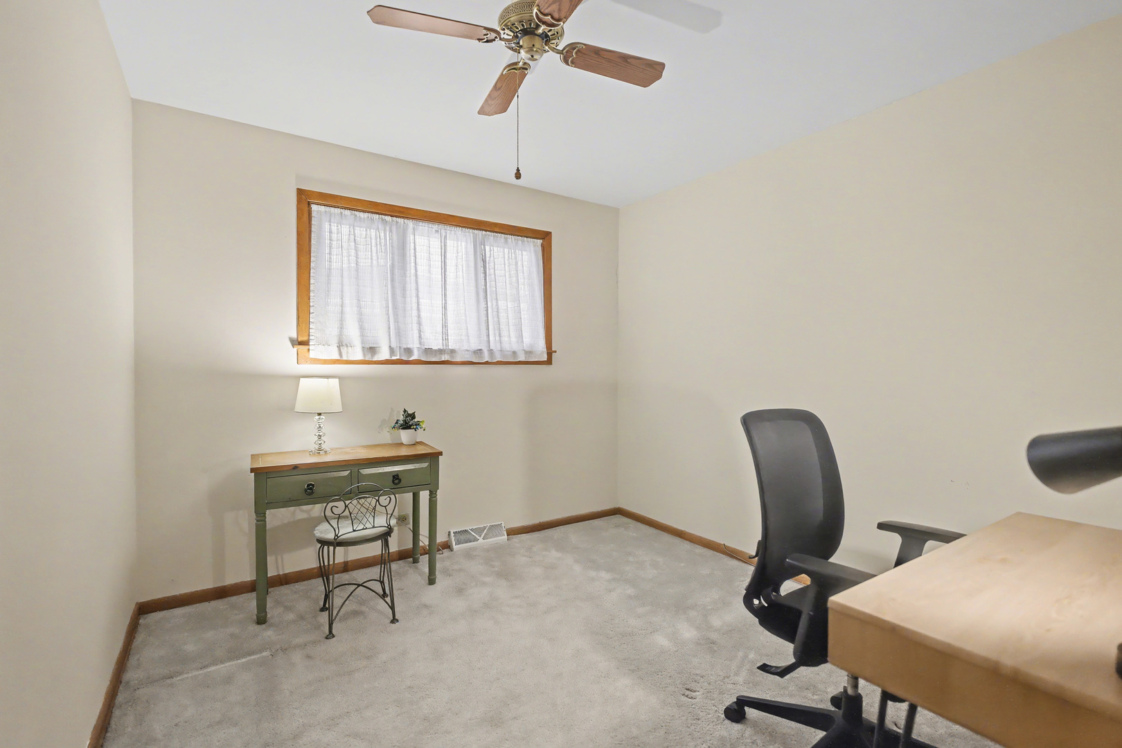 118 Evergreen Street Addison, IL 60101 - Photo 18 of 38 a view of a workspace with furniture and a window
