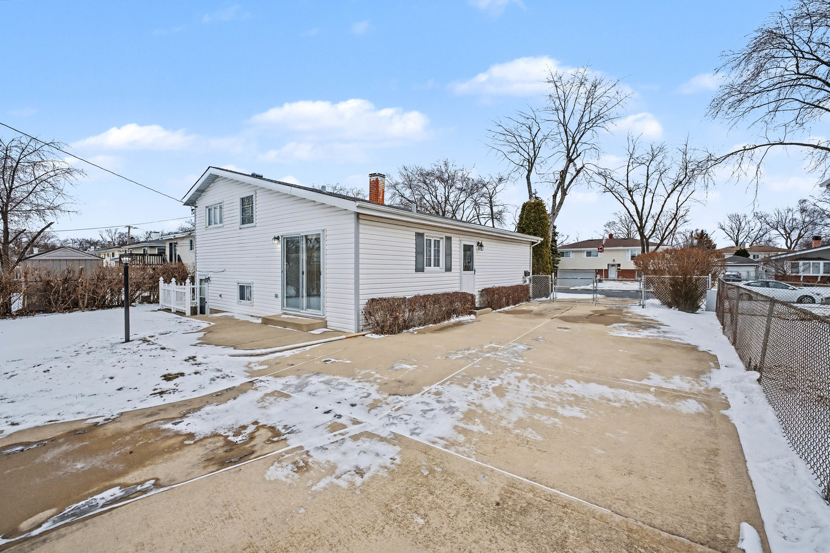 118 Evergreen Street Addison, IL 60101 - Photo 32 of 38 a view of a white house with a snow on the road
