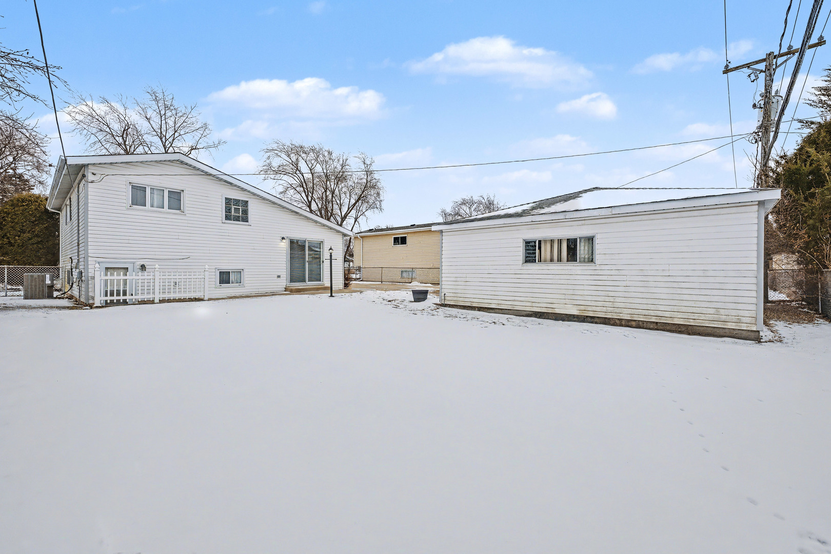 118 Evergreen Street Addison, IL 60101 - Photo 37 of 38 a view of a white house with a snow in the yard