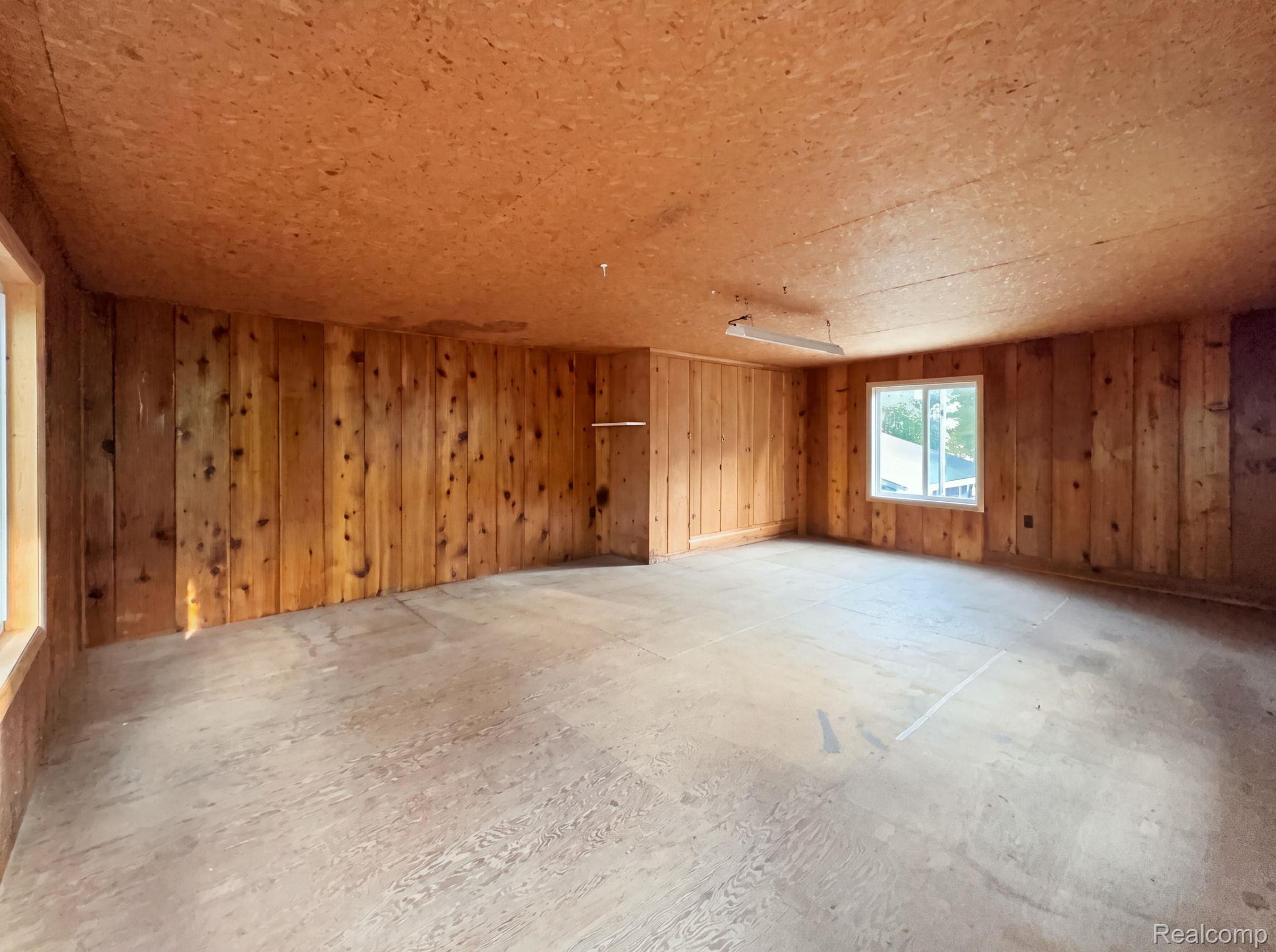 2259 Kassuba Road Gaylord, MI 49735 - Photo 39 of 46 Upper level of garage. Wood-paneled walls with a wood-finish ceiling and flooring