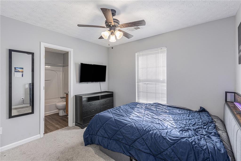 6536 Arbor Gate Drive Southwest, Unit 2 Mableton, GA 30126 - Photo 15 of 27 a bedroom with a bed and a flat screen tv