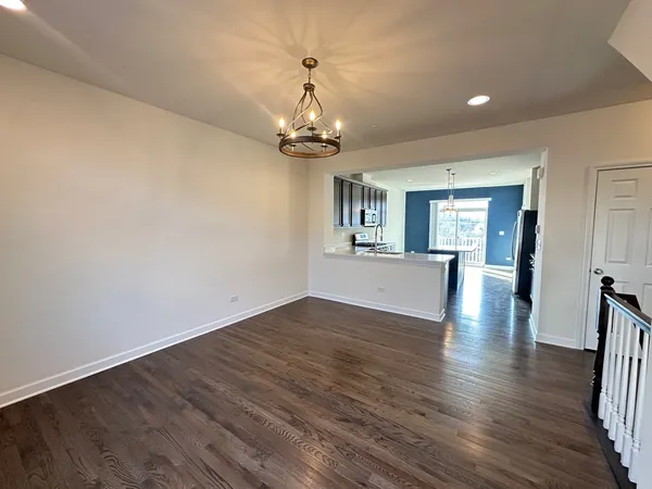 a view of livingroom with hardwood floor and kitchen view