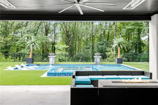 a large kitchen with kitchen island a large counter top space a sink appliances and a living room view