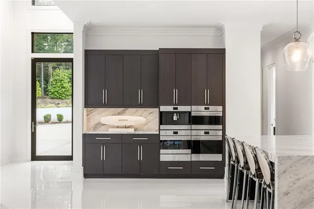 a view of a hallway with wooden floor and windows
