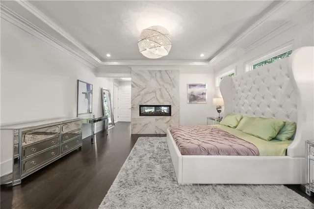 a bed sitting in a spacious bedroom next to a window