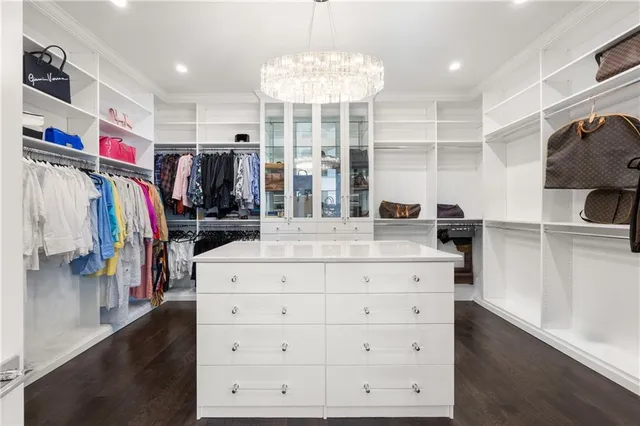 a living room with furniture a flat screen tv and a table