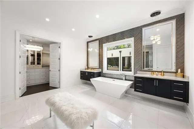 a kitchen with stainless steel appliances kitchen island granite countertop a table chairs and a refrigerator