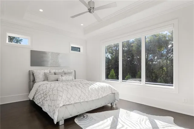 a view of a brick house with a big yard and large trees