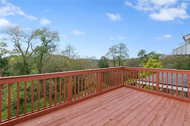 a balcony with wooden floor and fence