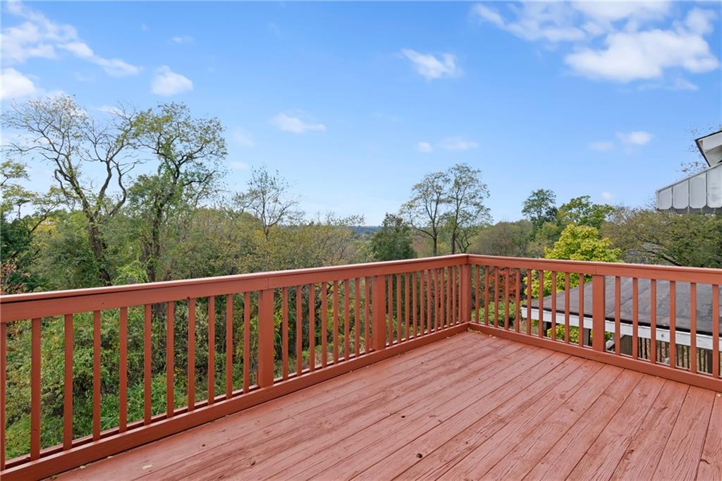 67 Semicir Street Pittsburgh, PA 15214 - Photo 17 of 36 a balcony with wooden floor and fence