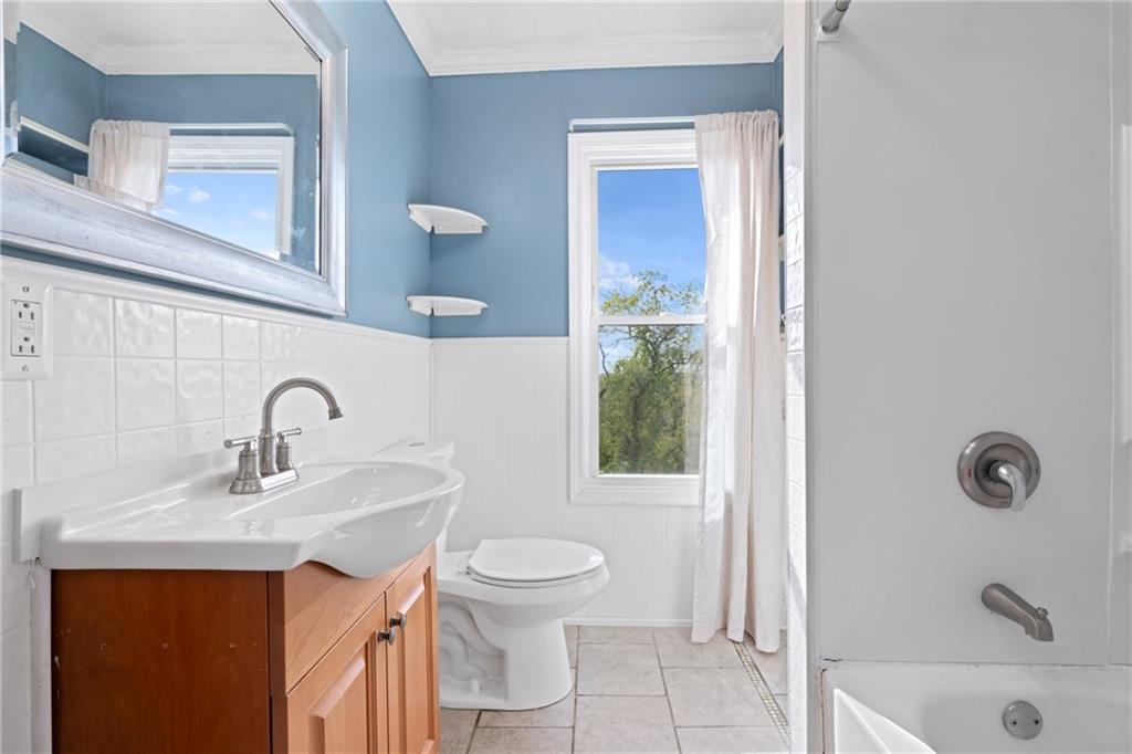 67 Semicir Street Pittsburgh, PA 15214 - Photo 19 of 36 a bathroom with a sink a toilet and shower