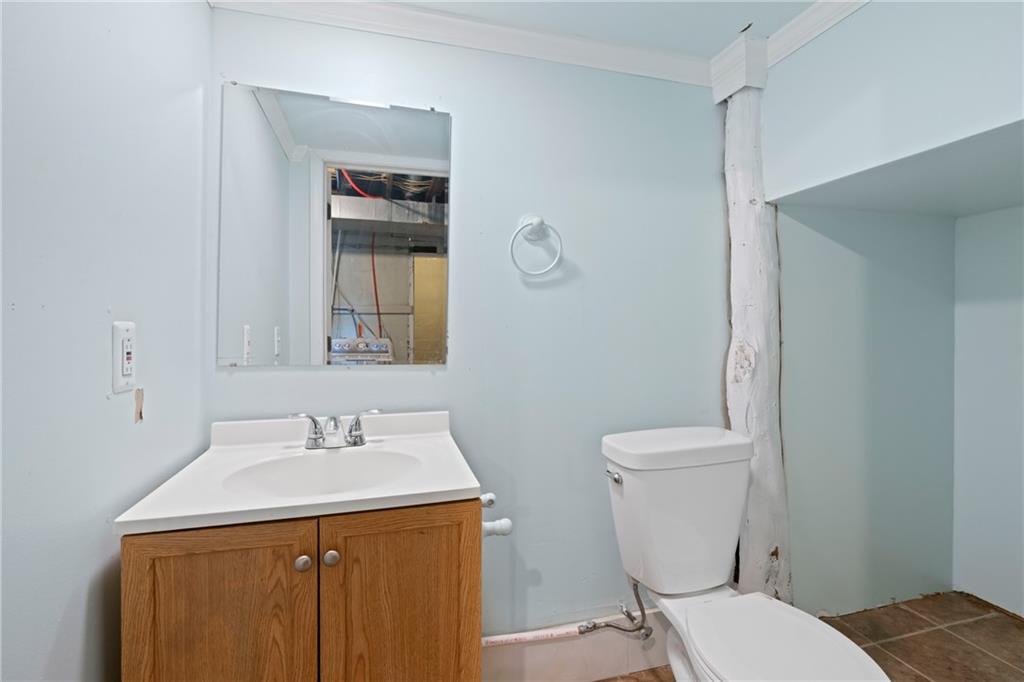 67 Semicir Street Pittsburgh, PA 15214 - Photo 29 of 36 a bathroom with a sink a toilet and mirror
