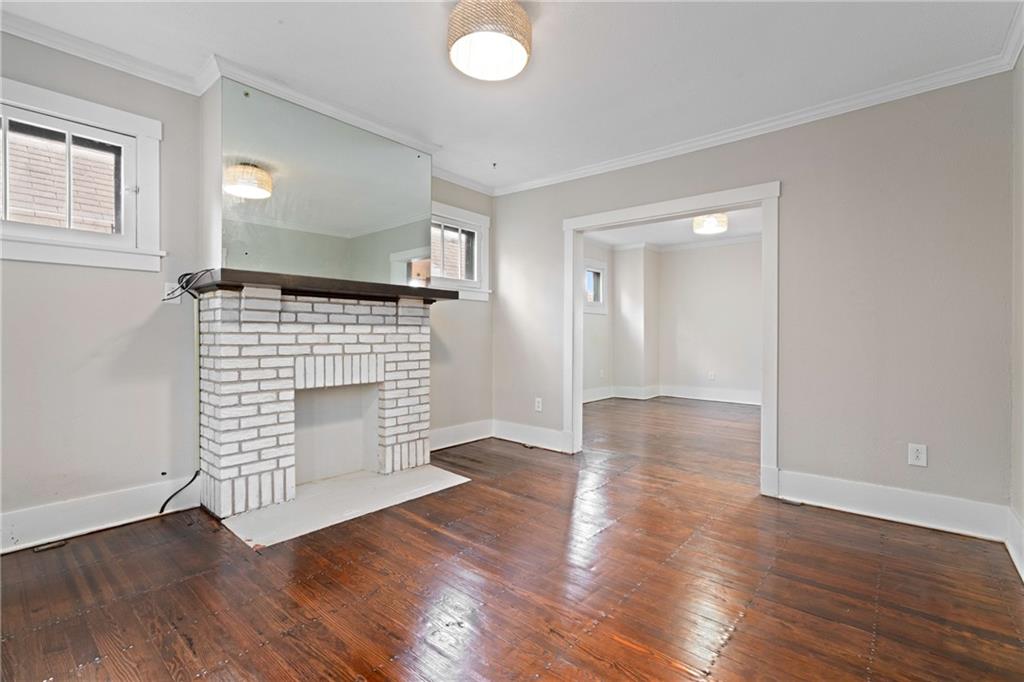 67 Semicir Street Pittsburgh, PA 15214 - Photo 10 of 36 an empty room with wooden floor and fireplace