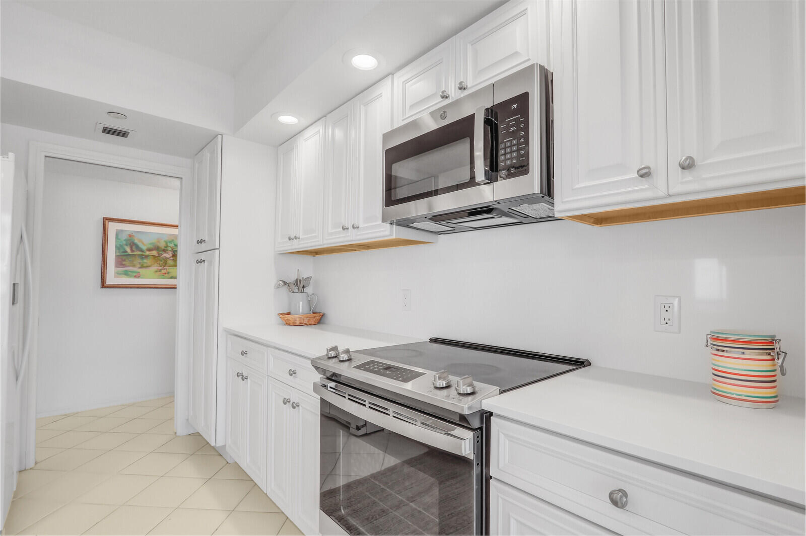 4100 North Ocean Drive, Unit 1501 Singer Island, FL 33404 - Photo 12 of 37 a kitchen with a stove microwave and sink
