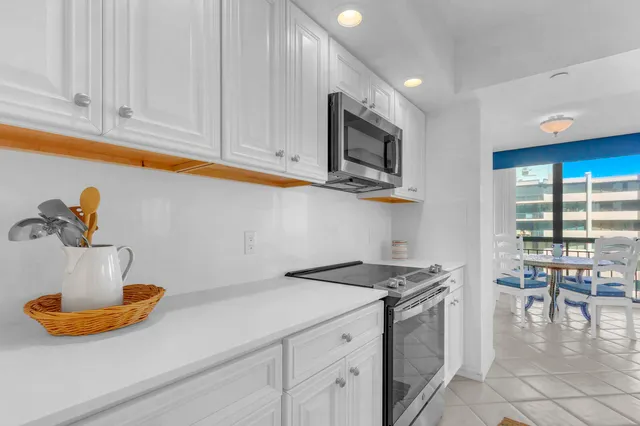a kitchen with stainless steel appliances granite countertop a sink a stove and cabinets