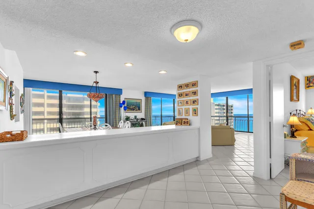 a large white kitchen with a large window