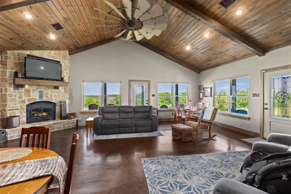 5555 Wright Road Sherman, TX 75092 - Photo 11 of 40 a living room with furniture a flat screen tv and a fireplace