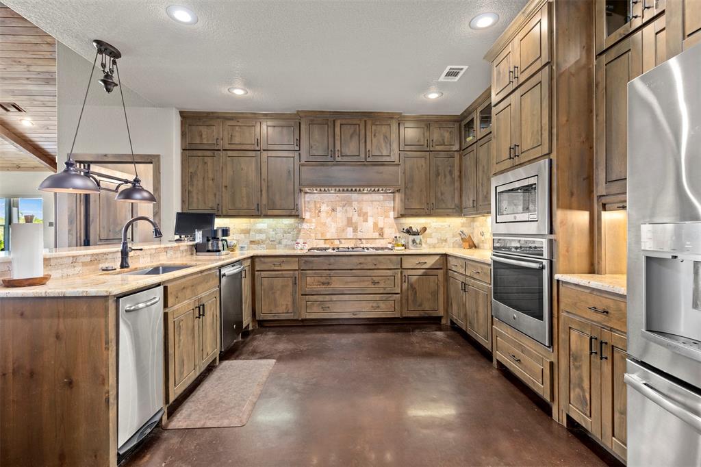 5555 Wright Road Sherman, TX 75092 - Photo 17 of 40 a kitchen with a sink refrigerator and cabinets
