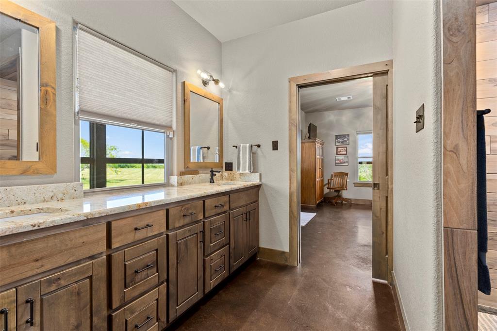 5555 Wright Road Sherman, TX 75092 - Photo 27 of 40 a spacious bathroom with a double vanity sink a mirror and a bathtub