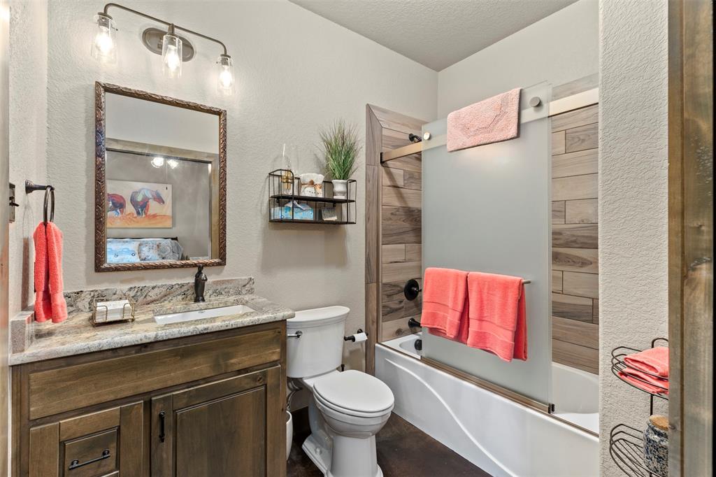 5555 Wright Road Sherman, TX 75092 - Photo 34 of 40 a bathroom with a toilet sink vanity and mirror
