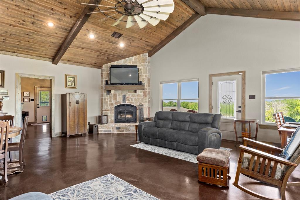 5555 Wright Road Sherman, TX 75092 - Photo 10 of 40 a living room with furniture a fireplace a flat screen tv and couches