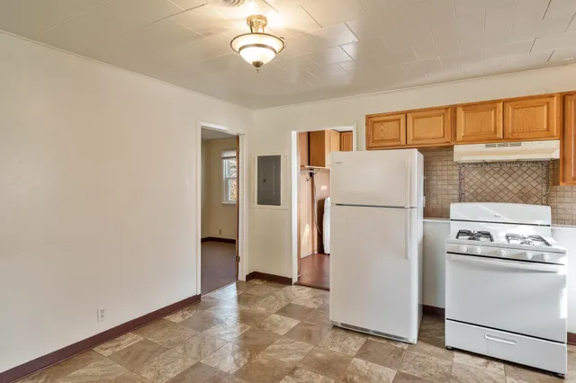 a white refrigerator freezer and a stove in a kitchen