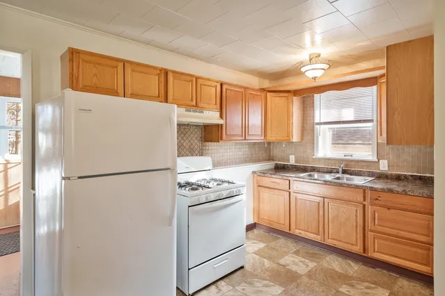 a kitchen with granite countertop a sink and a stove