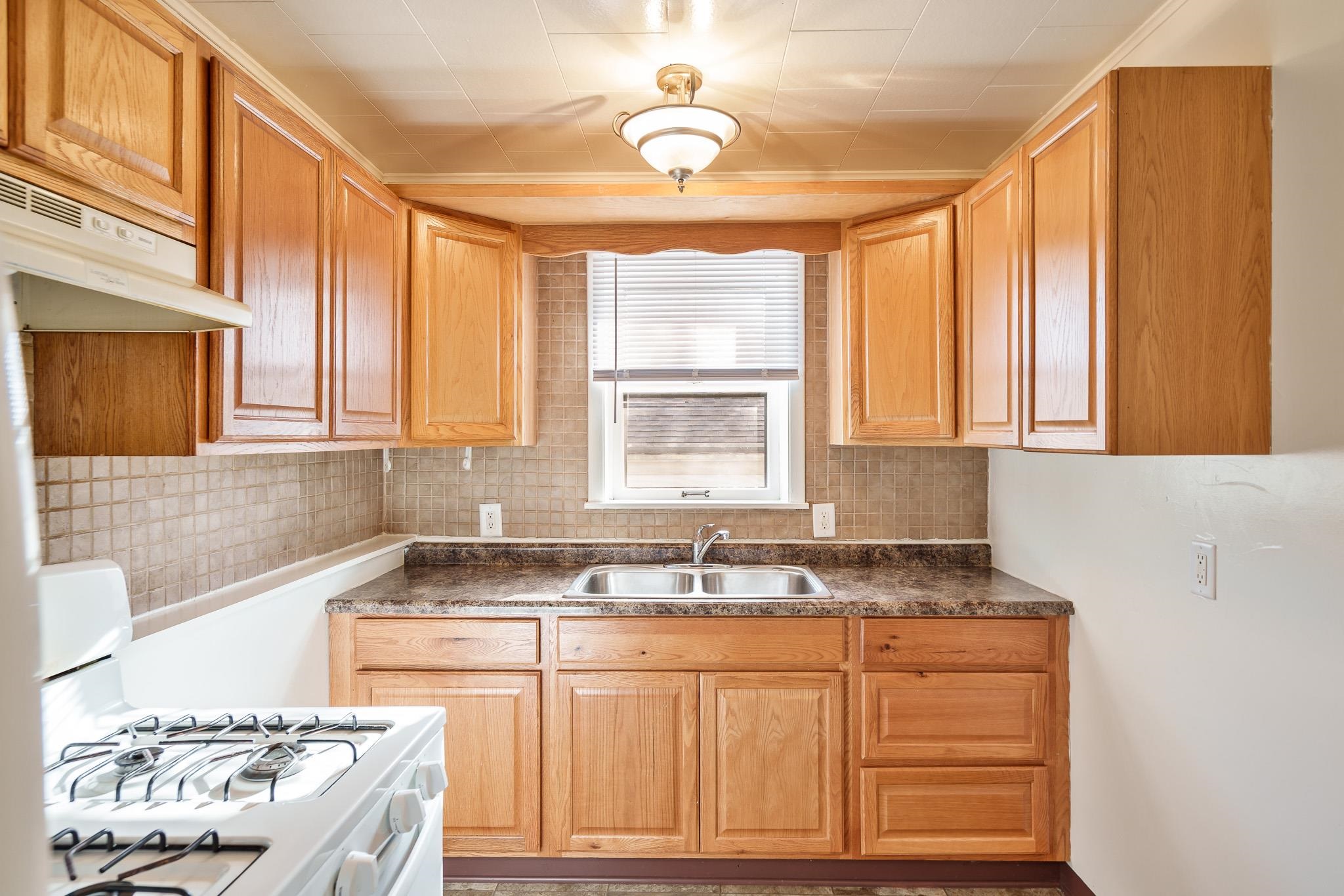 2016 Ridgeland Road Rockford, IL 61108 - Photo 17 of 28 a kitchen with granite countertop a sink and a stove