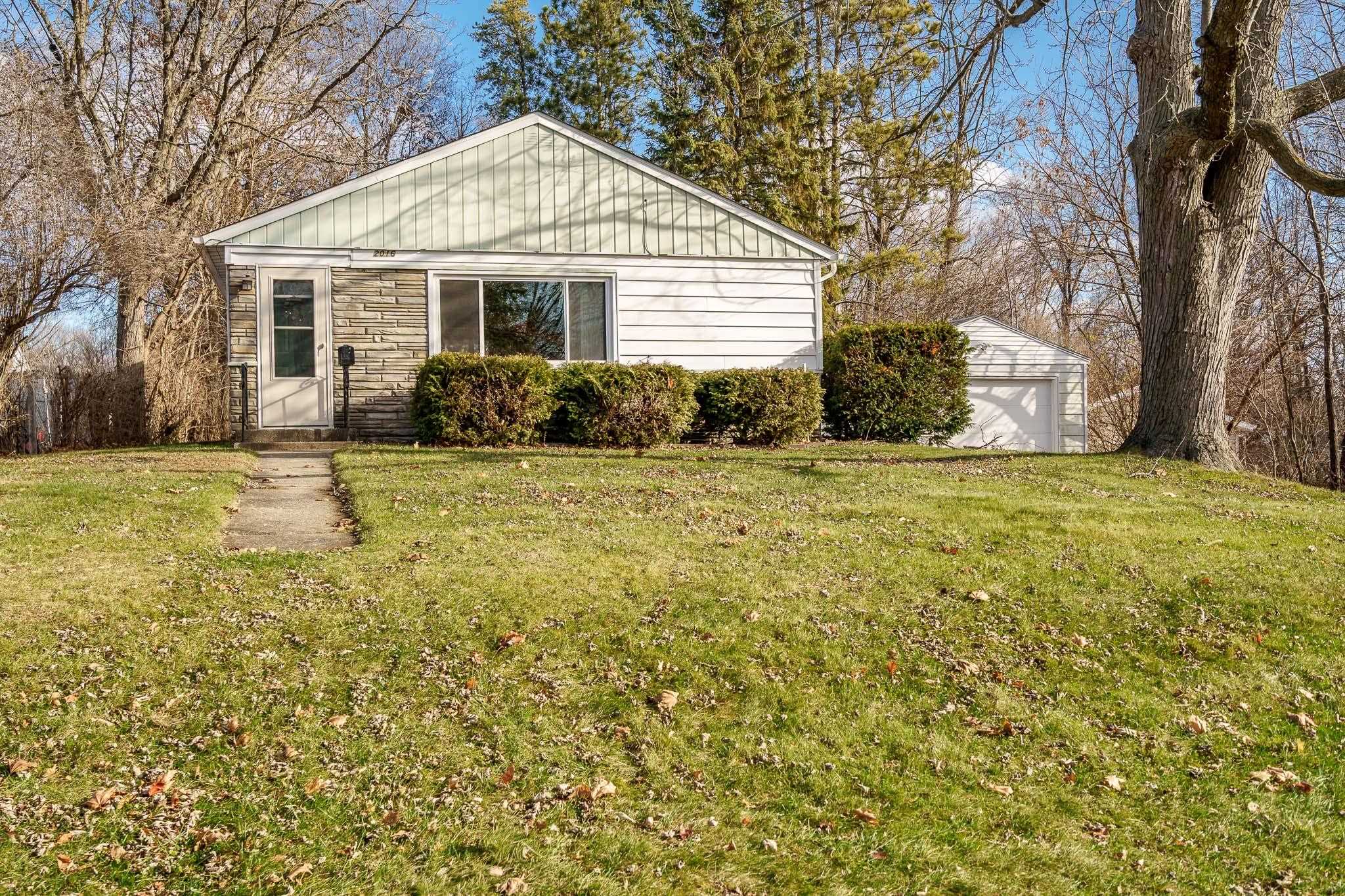 2016 Ridgeland Road Rockford, IL 61108 - Photo 3 of 28 a front view of a house with a garden