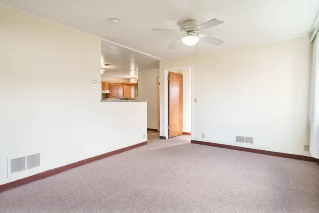 an empty room with windows and closet