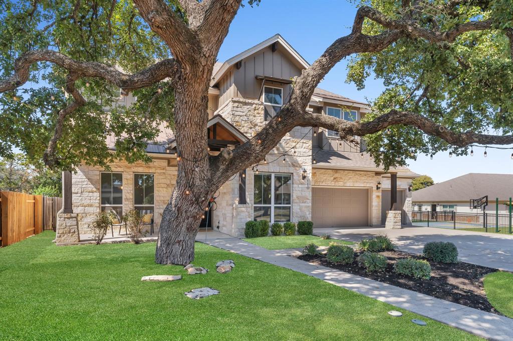 110 Magona Trail Georgetown, TX 78628 - Photo 3 of 38 Mature trees frame this elegant facade, boasting a two-car garage and verdant landscaping.