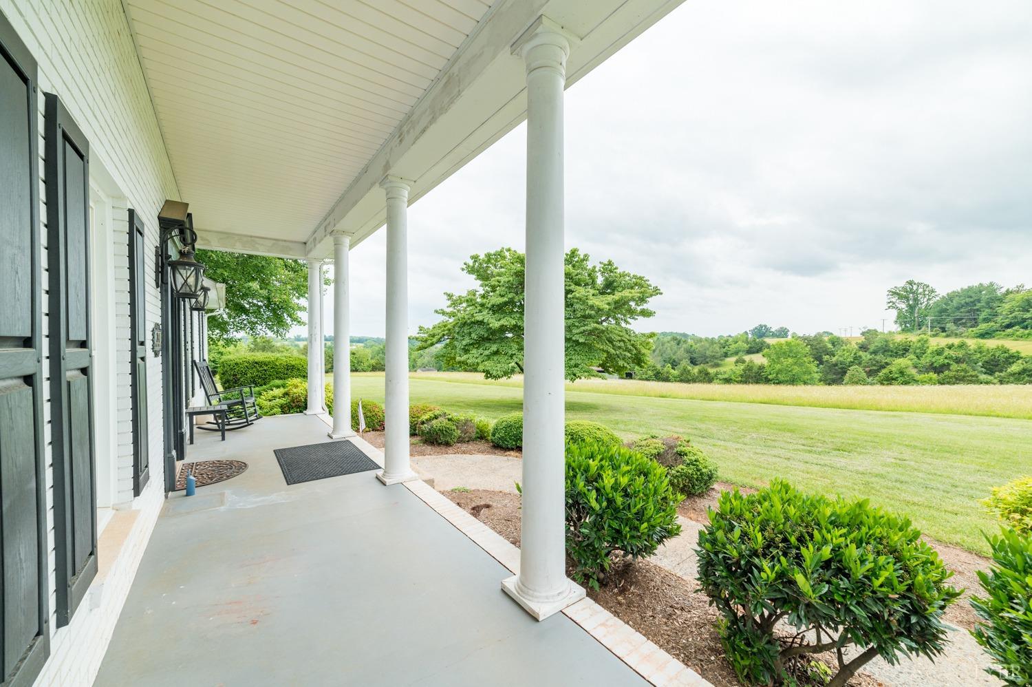 2901 Goode Station Road Goode, VA 24556 - Photo 5 of 57 a view of a balcony with lake view and a floor to ceiling window