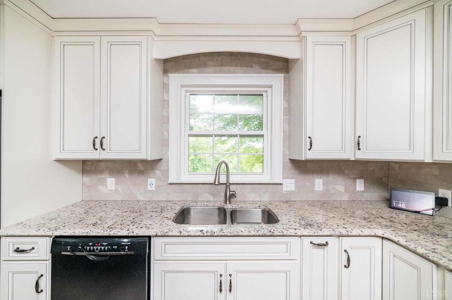 2901 Goode Station Road Goode, VA 24556 - Photo 53 of 57 a kitchen with granite countertop stainless steel appliances white cabinets and a window