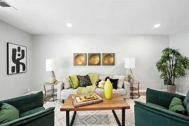 a living room with furniture and a potted plant on table