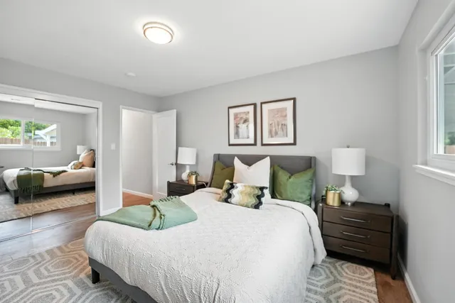 a bedroom with a bed and glass window