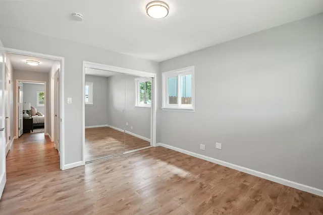 wooden floor in an empty room with a window