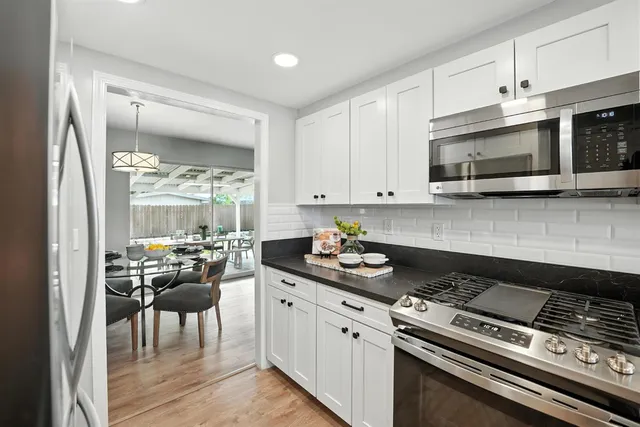 a kitchen with a stove a sink and a microwave