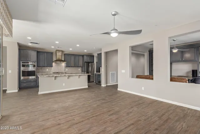 a view of kitchen with kitchen island white cabinets and stainless steel appliances