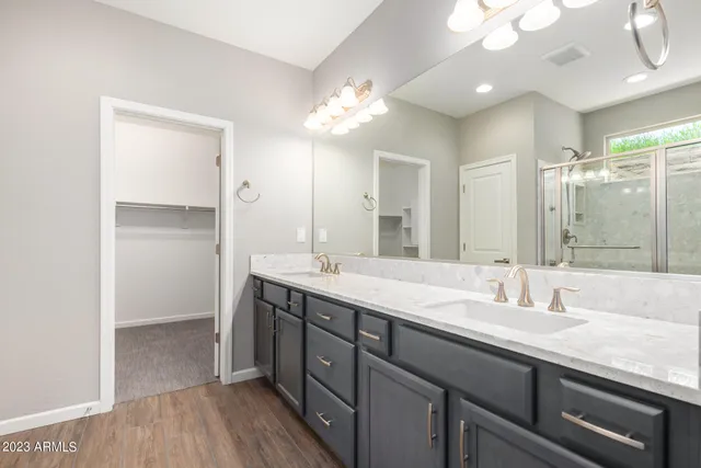 a bathroom with a double vanity sink and a mirror